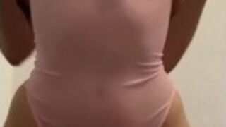 playing with her body, showing her breasts on camera.