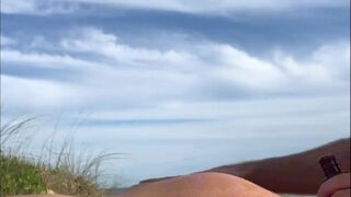 Redhead babe rests on the beach and then massages stranger's cock