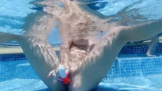 Three horny lesbian girls with big tits have fun playing with their dildo in the swimming pool
