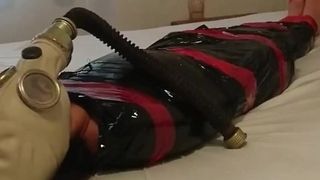 'BDSM Slave Girl, plastic mummification with gasmask Breathplay'